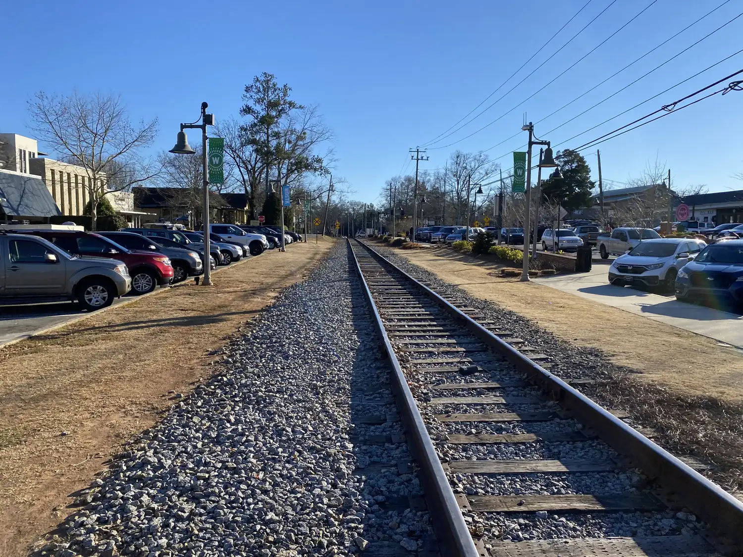 The railroad through downtown Woodstock, with shops and parking along the tracks